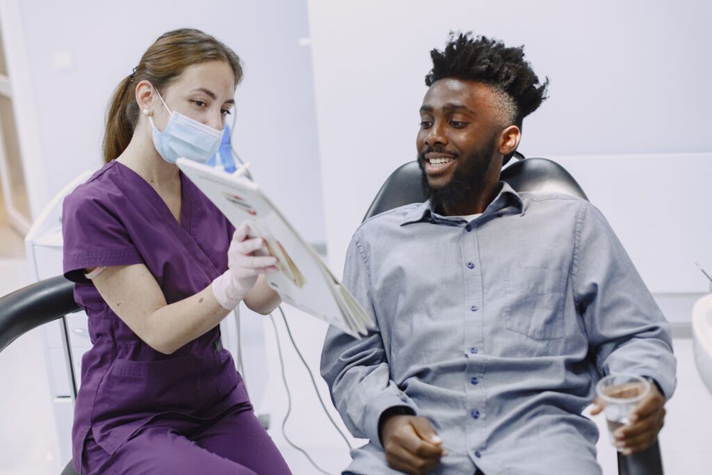 Dental professional discussing oral health information with a patient during a consultation