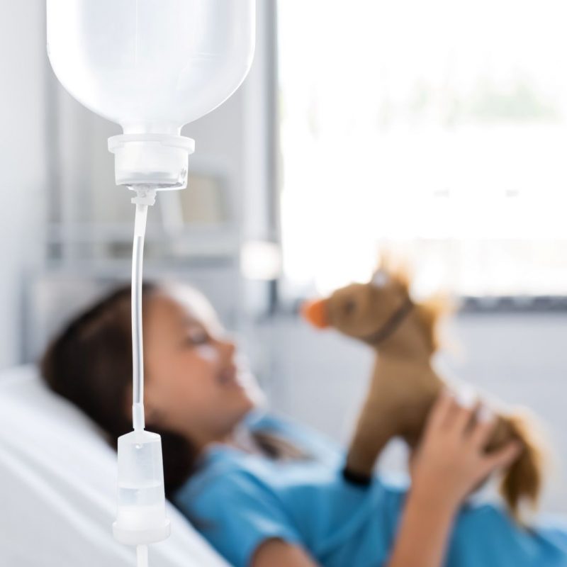 bottle-of-intravenous-therapy-near-blurred-kid-wit-2026-03-26-23-39-39-utc