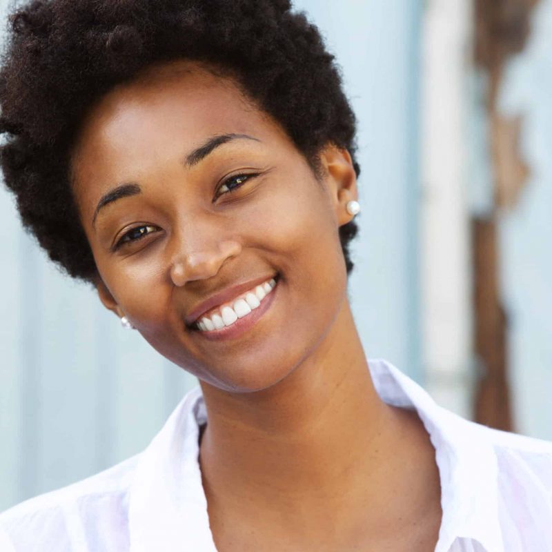 Close up portrait of a happy young african woman with beautiful smile on her face